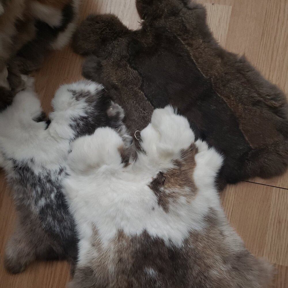 A MYSTERY BAG OF 2 PIECES RABBIT PELTS
